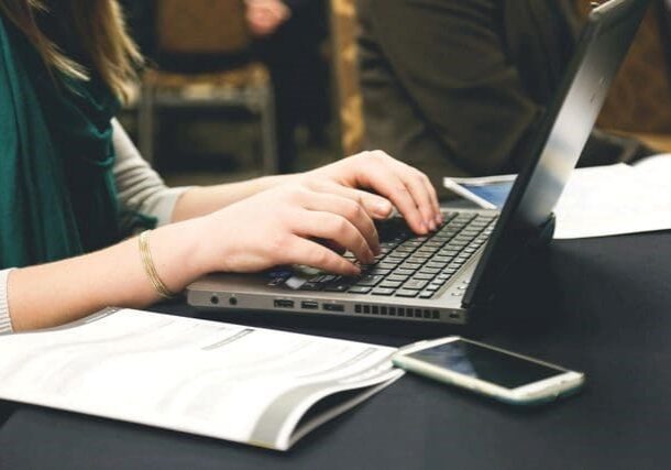 A person typing on a laptop computer.